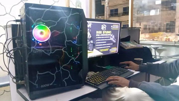 The design desk with a poster being designed on screen
