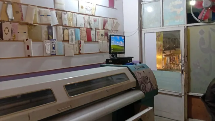 Inside Digital World: a wall of card samples and the large-format printer